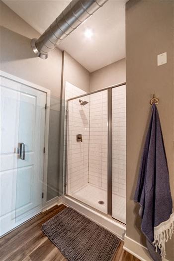 a bathroom with a shower and a blue towel at The Foundry, Indiana, 46617